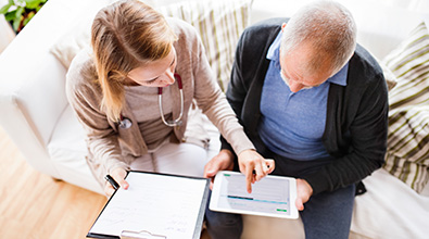 Home Health nurse discussing care with a patient.